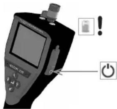 Diagram of a medical device with labeled buttons and icons, including a battery icon and power button