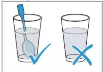 Illustration showing a blue spoon inside a glass with a checkmark and an 'X' mark, indicating incorrect water quality.