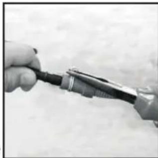 Close-up of a hand holding a small electronic device with wires (no visible text or symbols)