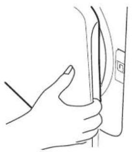 Line drawing of a hand holding a medical or surgical instrument near a vertical tube (no text or symbols present)