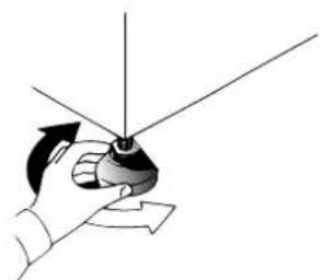 Hand holding a small mechanical component with directional arrows indicating rotation (no text or symbols)
