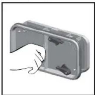 Hand inserting a component into a metal enclosure (no text or symbols visible)