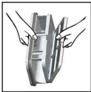 Illustration of two hands holding a rectangular object with internal lines (no text or symbols)