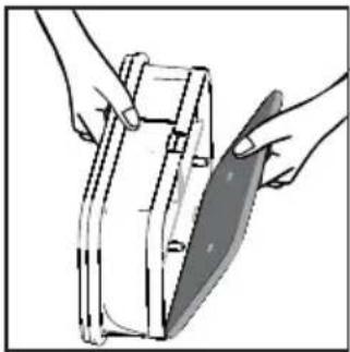 Illustration of hands using a tool to cut a rectangular object with a knife (no text or symbols visible)