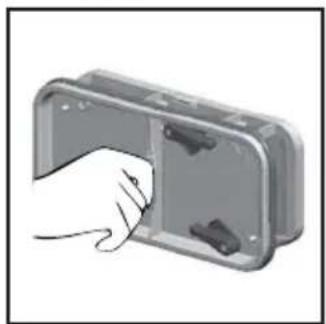 Hand inserting a component into a metal enclosure (no text or symbols visible)