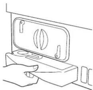 Line drawing of a hand pressing down on a device with a handle (no text or symbols)