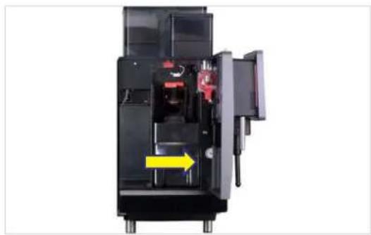 Interior view of a black industrial machine with visible internal components and a yellow arrow indicating direction (no text or symbols)