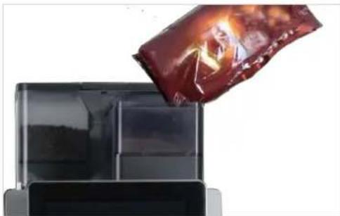 Black rectangular object with a glossy surface and a red, glossy, irregularly shaped container (no text or symbols visible).