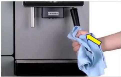 Hand cleaning a stainless steel appliance with a blue cloth, no visible text or symbols.