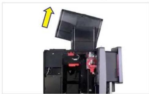 Interior view of a black industrial machine with red clamps and a yellow upward arrow indicating motion (no text or symbols visible)