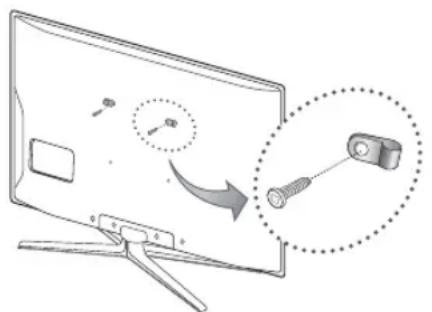 Diagram illustrating a cable or connector being inserted into a monitor, with magnified detail showing the component's insertion.