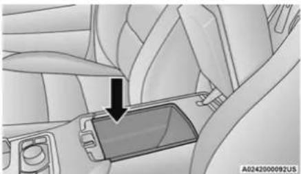 Interior view of a car showing a hand adjusting a device (no text or symbols visible)