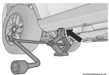Mechanical assembly diagram showing a wheel connected to a bracket with a directional arrow indicating motion (no text or symbols present)
