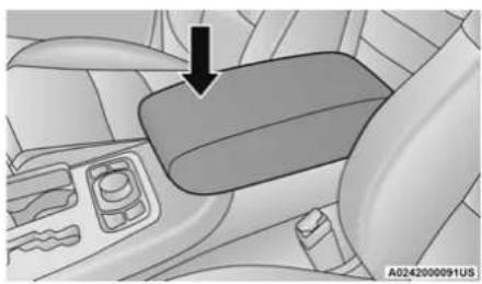 Interior view of a car showing a car seatbelt with a black arrow pointing to the side panel (no text or symbols visible)