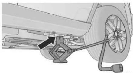 Mechanical assembly diagram showing a car wheel connected to a bracket and cable (no text or symbols visible)