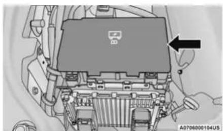 Interior view of a vehicle engine bay with a black arrow pointing to the component (no visible text or symbols)