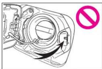 Diagram of a mechanical component with an arrow indicating direction and a pink prohibition symbol (no text or labels)
