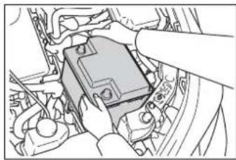 Illustration of hands installing or adjusting a car engine block (no text or symbols visible)