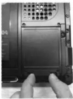 Close-up of hands pressing a button on a device (no visible text or symbols)