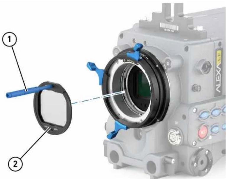 Technical diagram of a camera module with labeled parts, showing component 1 and part 2 with blue tool pins.