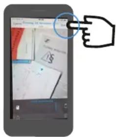 Smartphone screenshot showing a hand pointing at a document with visible text and a dollar sign, likely from a web interface or app.
