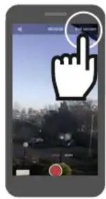 Smartphone screenshot showing a hand cursor clicking a button on a city street interface, with Chinese UI elements visible.