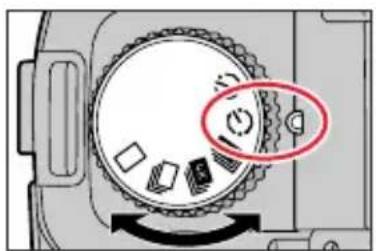 Diagram of a camera dial with labeled buttons and directional arrow, highlighting one button as a highlighted section.