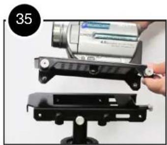 Close-up of a hand holding a digital camera module mounted on a black stand, no visible text or symbols