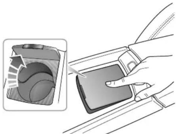 Illustration of a hand inserting a device into a car seatbelt, showing the interior and side view (no text or symbols)