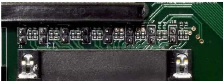 Close-up of a green printed circuit board with multiple connector pins and connectors (no visible text or symbols)