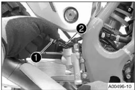 Mechanical assembly diagram showing a worker adjusting components with numbered labels ① and ②, likely for repair or maintenance.