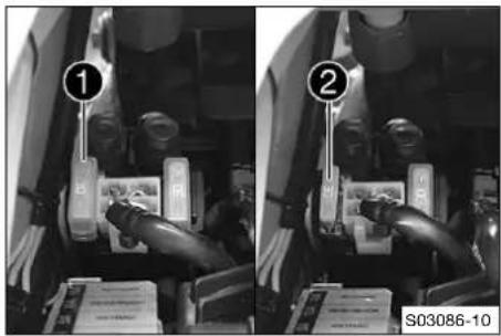 Black-and-white photo showing two identical mechanical components with numbered labels (① and ②) and a label S03086-10 below.