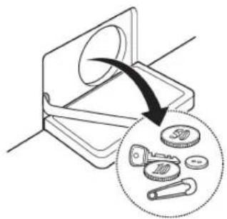 Diagram showing a mechanical component being inserted into a slot, with an arrow indicating the direction and a magnified inset showing key positions.