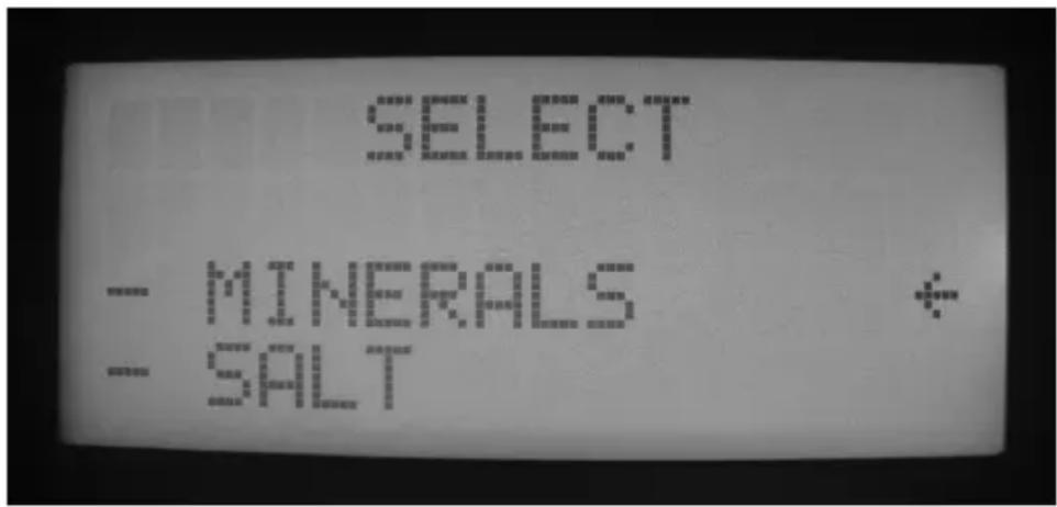 Scanned document with pixelated text and a small logo, likely from a technical or legal document.