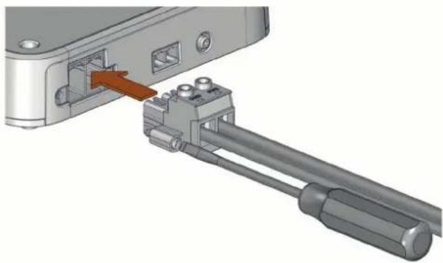 3D mechanical assembly showing a connector inserted into a device with a red arrow indicating the insertion point (no text or symbols visible)