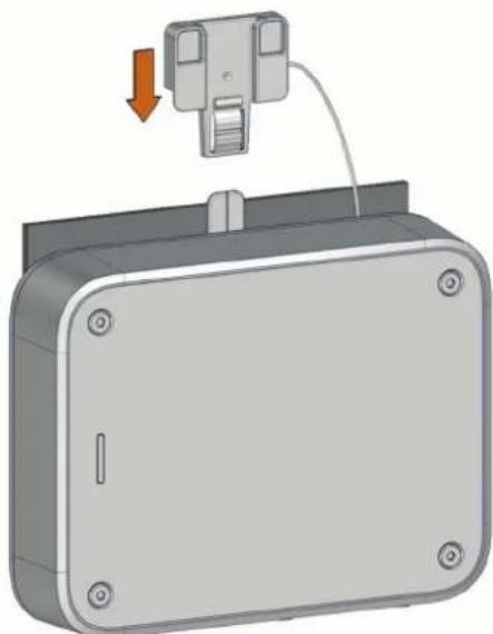 3D rendering of a mechanical device with a cable and mounting bracket, showing a red arrow indicating direction (no text or symbols)