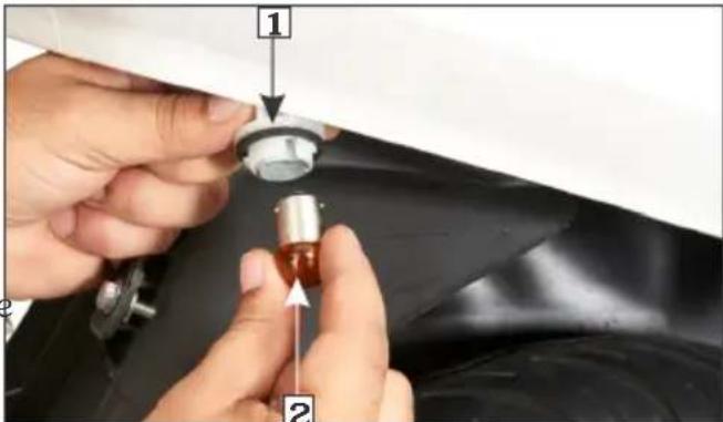 Close-up of hands installing a mechanical component with numbered callouts and arrows indicating assembly steps