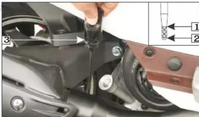 Close-up of a mechanical component with numbered parts and a close-up view showing labeled parts 1 and 2.