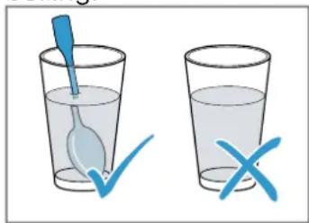Illustration showing a blue spoon inside a glass with a checkmark and an 'X' symbol, indicating incorrect eye condition.