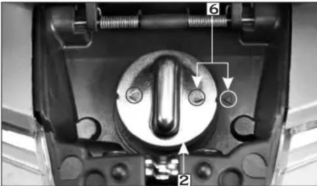 Technical diagram of a mechanical component with numbered parts and directional arrows indicating assembly or movement.