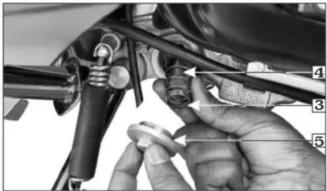 Close-up of a hand adjusting automotive brake calipers with numbered labels pointing to components