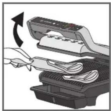 Illustration of a hand using a scanner to clean or wash clothes from a machine (no text or symbols visible)