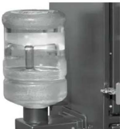 Close-up of a transparent cylindrical device with a central rod, mounted on a base (no visible text or symbols)