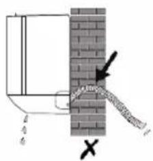 Diagram showing a pipe or pipe connection between a container and a brick wall, with an arrow indicating direction of flow.