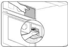 Illustration of a hand inserting a device into a door, showing the interior and exterior view (no text or symbols)