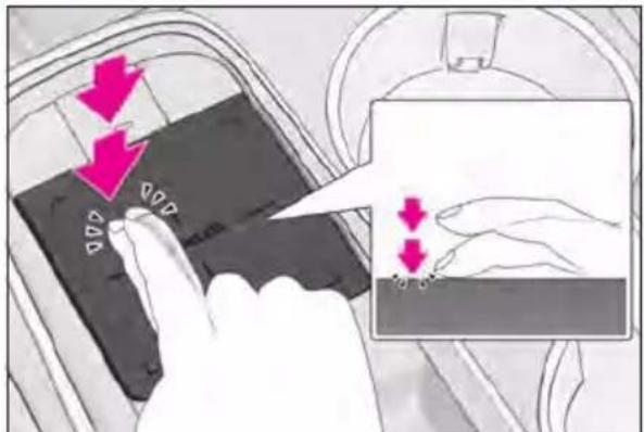 Diagram showing hand positioning of a device with directional arrows and magnified detail view