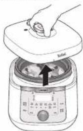 Diagram showing a hand pressing down on a food processor with a control panel and directional arrow indicating rotation or movement.