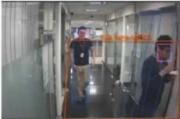 Street photo with visible store signboards and people wearing masks on a glass corridor