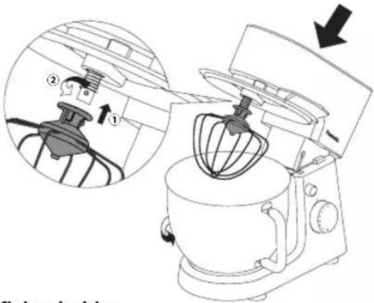Diagram of a kitchen mixer with labeled parts and directional arrow indicating rotation or adjustment