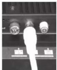 Close-up of a black electronic device with two connected ports and a white cable (no visible text or symbols)